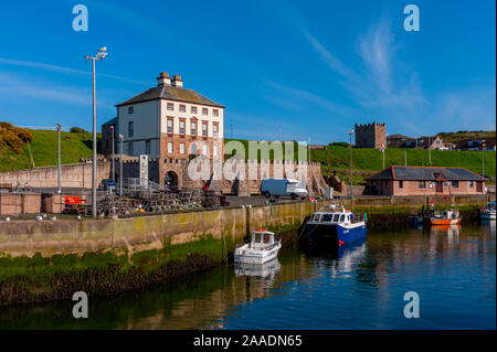 The harbour at Eyemouth with Gunsgreen House overlooking harbour Stock Photo