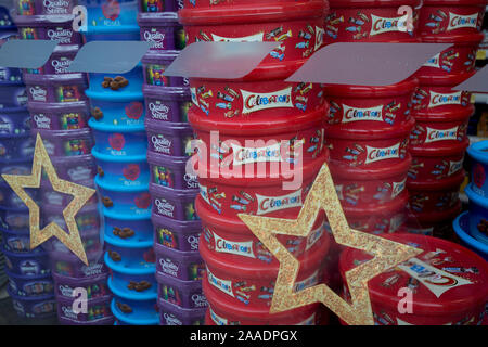 A display of assorted chocolate and sweet boxes of Nestle Quality Street, Cadburys Roses and Heroes plus Mars Celebrations piled up in the Christmas themed window of a local Tescos supermarket, on 20th November 2019, at Smithfield in the City of London, England. Stock Photo