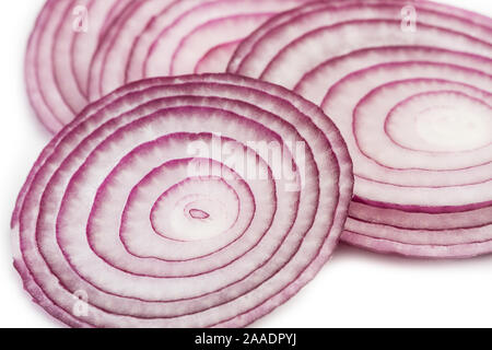 Slices of purple onion in a top view on a white background Stock Photo