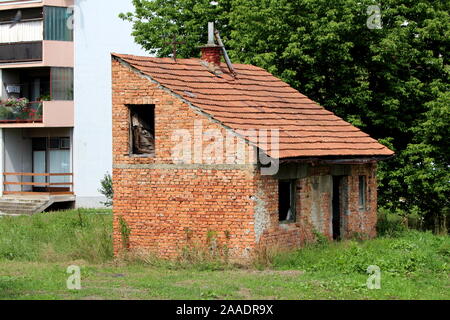 A Red Brick House Stands Surrounded By Trees On Top Of A Hill In