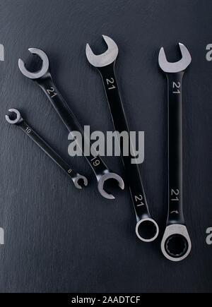 Professional reinforced Open end and Spanner Wrench tools placed on a dark background. View from the top. Stock Photo