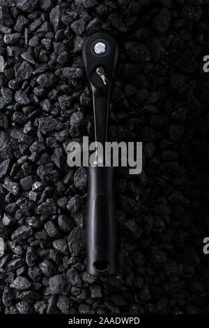 Professional reinforced black matt hex wrench placed on a stony background. View from the top. Stock Photo
