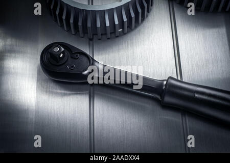 Reinforced professional black matt hex wrench placed on a polished aluminum surface. View from the top. Stock Photo