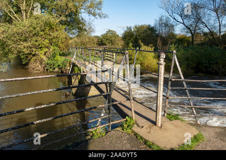 Narrow footbridge over the old sluice gates of Thirsk mill at Cod Beck Thirsk North Yorkshire England UK United Kingdom GB Great Britain Stock Photo