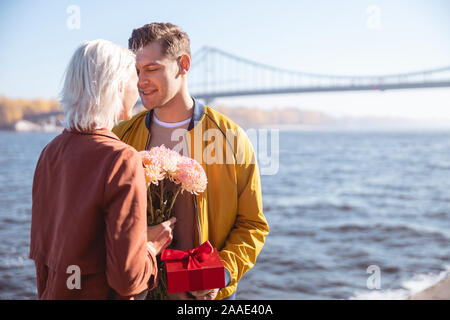 Man giving his girlfriend her birthday gift Stock Photo