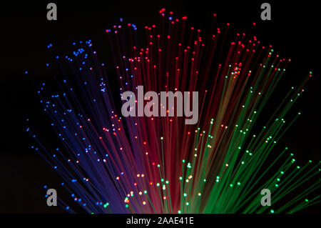 Red green blue primary colours being transmitted along glass fibre cables possible use of wavelength communication in IT and data transmission Stock Photo