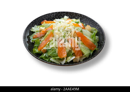 Fresh salad caesar with salmon and parmesan in beautiful black modern plate Stock Photo