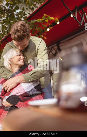 Pretty woman smiling in hands of her boyfriend Stock Photo