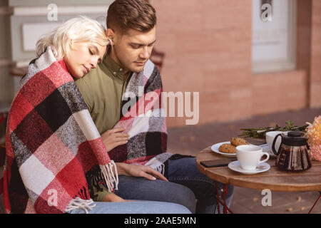 Beautiful woman feeling safe near her boyfriend Stock Photo