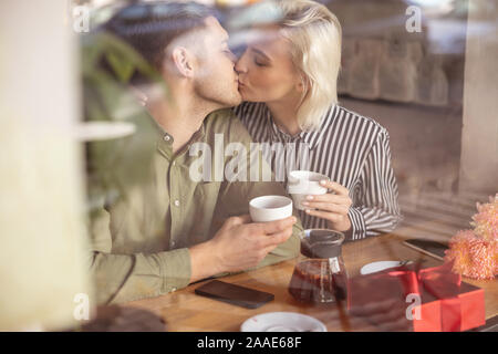 Beautiful couple having their first kiss on the date