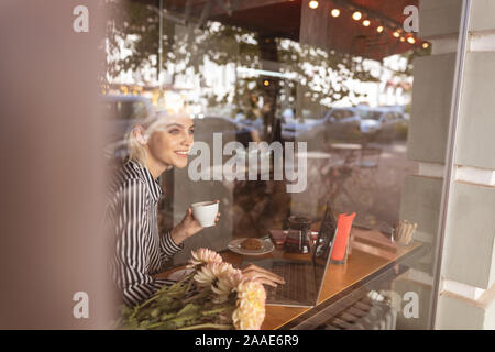 Cheerful lady feeling happy working on her project Stock Photo