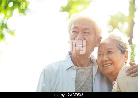 portrait of loving senior asian couple enjoying good time outdoors in park Stock Photo