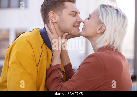 Happy loving couple almost kissing each other Stock Photo