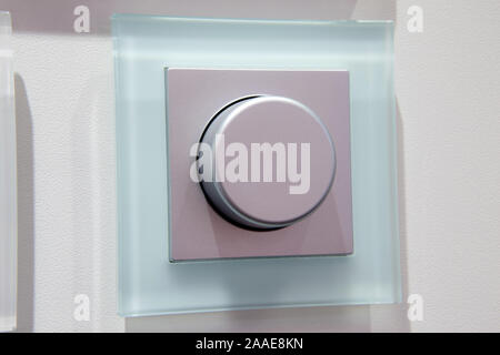 modern electric dimmer switch on wall closeup Stock Photo