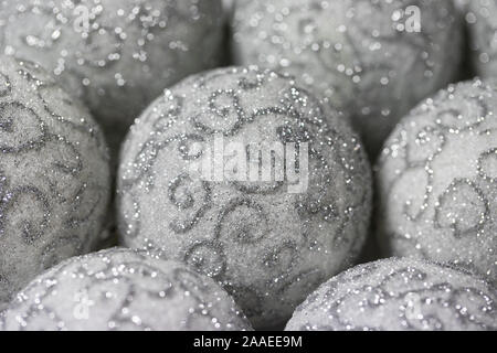 Christmas background. White Christmas balls with silver pattern close-up. Beautiful Christmas Wallpaper. Stock Photo