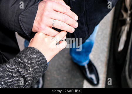 Wedding rings on his hands. An elderly couple got married. Happy family. Family outdoors Stock Photo