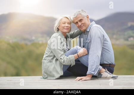 Loving full length portrait of modern senior couple outdoors Stock Photo