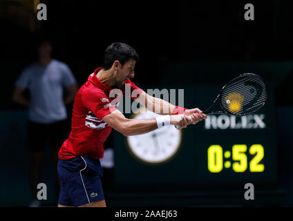 Novak Djokovic of Serbia plays a backhand against Benoit Paire of France during Day 4 of the 2019 Davis Cup at La Caja Magica in Madrid, Spain. Novak Djokovic of Serbia in action against Benoit Paire of France during Day 4 of the 2019 Davis Cup at La Caja Magica. Stock Photo