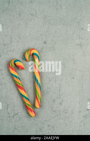 stick candy canes on a green background for new year Stock Photo