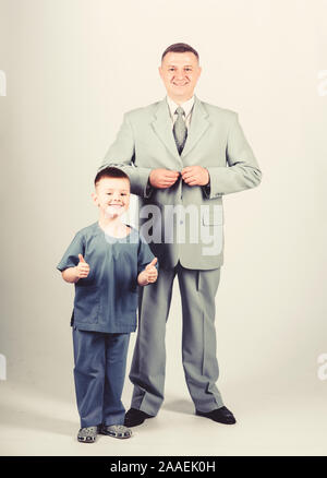 future career. childhood. trust and values. fathers day. family day. father and son in business suit. male fashion. happy child with father. business partner. small boy doctor with dad businessman. Stock Photo