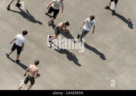 teenagers play basketball on the yard court Stock Photo