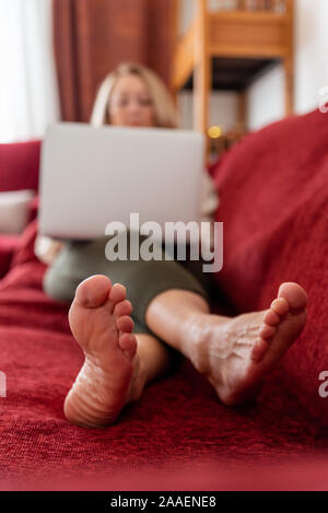 Elegant mature woman using computer at home Stock Photo