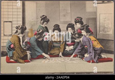 Illustrated postcard of a group of Japanese young women dressed in traditional clothing kneeling on the floor and playing Uta-garuta, a traditional Japanese card game, Japan, 1920. From the New York Public Library. () Stock Photo