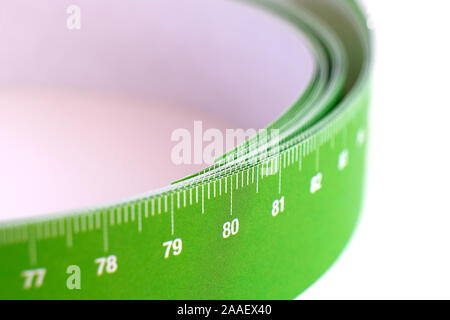 Meter tape for measuring rolled into a roll, on a light background. Selective focus Stock Photo