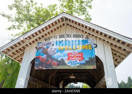 Low-angle view of the Roaring Camp covered bridge, originally construction in 1964 in Felton, California, with banner for Day Out With Thomas railroad event, July 26, 2019. () Stock Photo