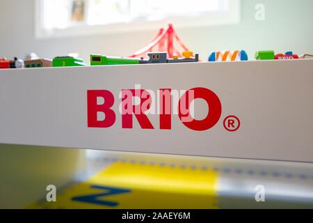 Close-up of logo for Swedish wooden toy company Brio on child's train table in nursery setting, with trains and toys partially visible atop the table, August 27, 2019. () Stock Photo