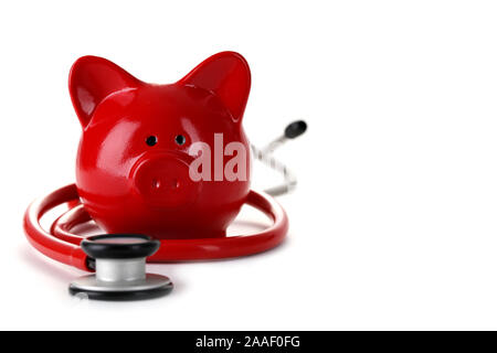 Red piggy bank with stethoscope isolated on white Stock Photo