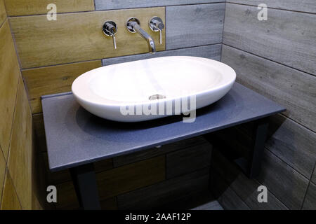 Classic modern white washbasins with chrome water tap and soap dish Stock Photo
