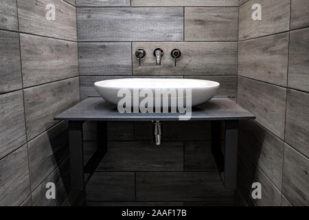 Classic modern white washbasins with chrome water tap and soap dish Stock Photo