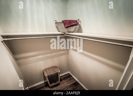 White windowless walk-in closet with tall cabinet in the middle Stock Photo  - Alamy