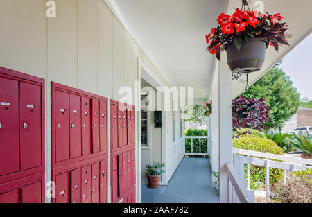 The office at Four Seasons apartments is pictured with mailboxes in Mobile, Alabama. The apartment complex is managed by Sealy Management Company. Stock Photo