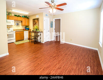 An eat-in kitchen and empty living room is pictured at Robinwood Apartments in Mobile, Alabama. Stock Photo