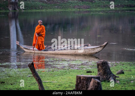 Monk in the boat near of the Gate to the Bayon temple, Siem Reap, Cambodia, Asia. Stock Photo