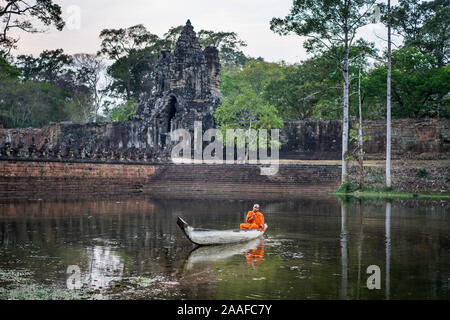 Monk in the boat near of the Gate to the Bayon temple, Siem Reap, Cambodia, Asia. Stock Photo