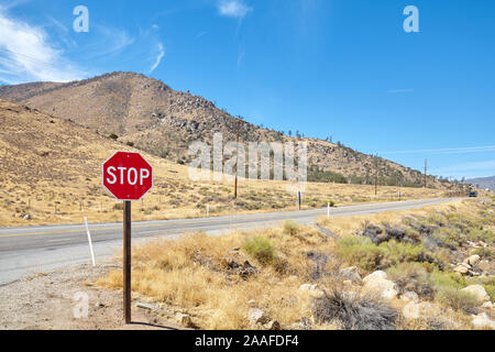 Stop sign by a road in Nevada, focus on traffic sign, USA.