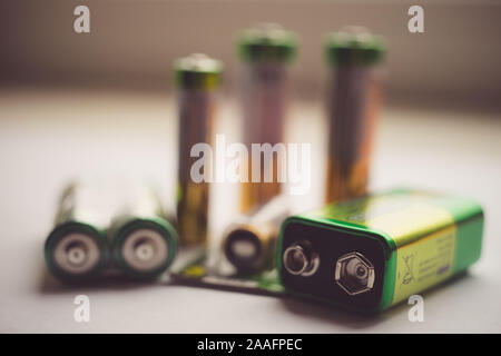Different types of new batteries on the table close-up. Stock Photo