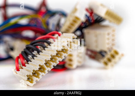 Electric cables and connectors for transmitting electricity. Old plugs used in electrical equipment. Light background.q Stock Photo