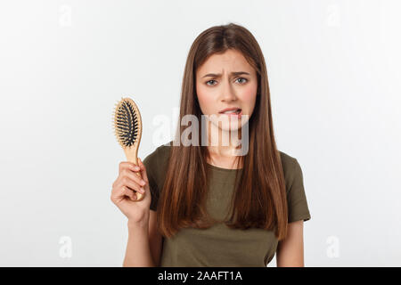 Unhappy frustrated woman surprised she is losing hair 