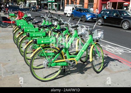 Lime E electric bikes on pavement in Holloway Road at Highbury Corner, London Borough of Islington Stock Photo