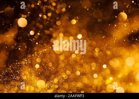 Splash of golden sparkles on black background. Stock Photo