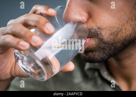 Close-up Of A Man's Hand Drinking Glass Of Water Stock Photo