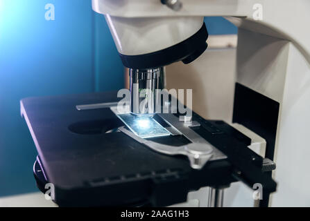 Scientific or medical test sample under light microscope in laboratory, close up. Stock Photo