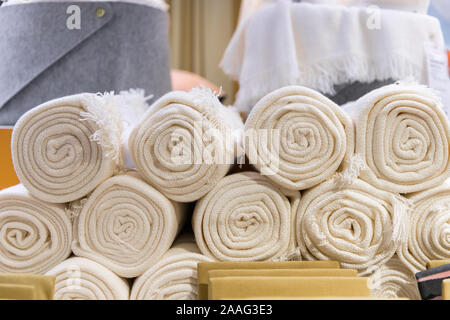 Rolled up white towels at textile shop Stock Photo