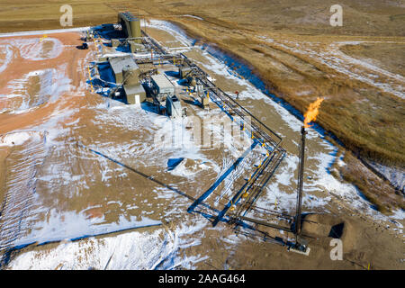 Watford City, North Dakota - Natural gas is flared off at an oil production facility in the Bakken shale formation. Stock Photo