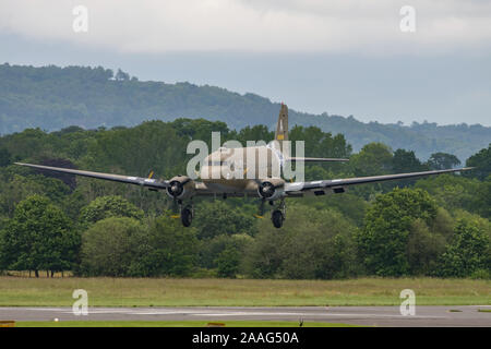 A Douglas C-47 Skytrain WW2 transport aircraft landing at Dunsfold Aerodrome, UK during the last ever Wings & Wheels airshow on the 16th June 2019. Stock Photo