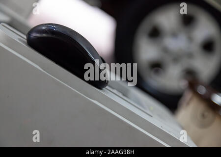 A black wireless mouse sliding diagonally down in the office during a working day. Stock Photo